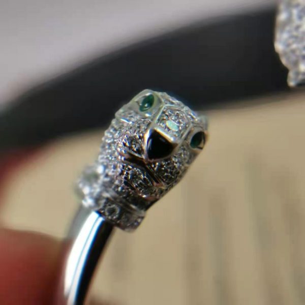 PANTHÈRE DE CARTIER BRACELET, WHITE GOLD, EMERALDS, ONYX, DIAMONDS