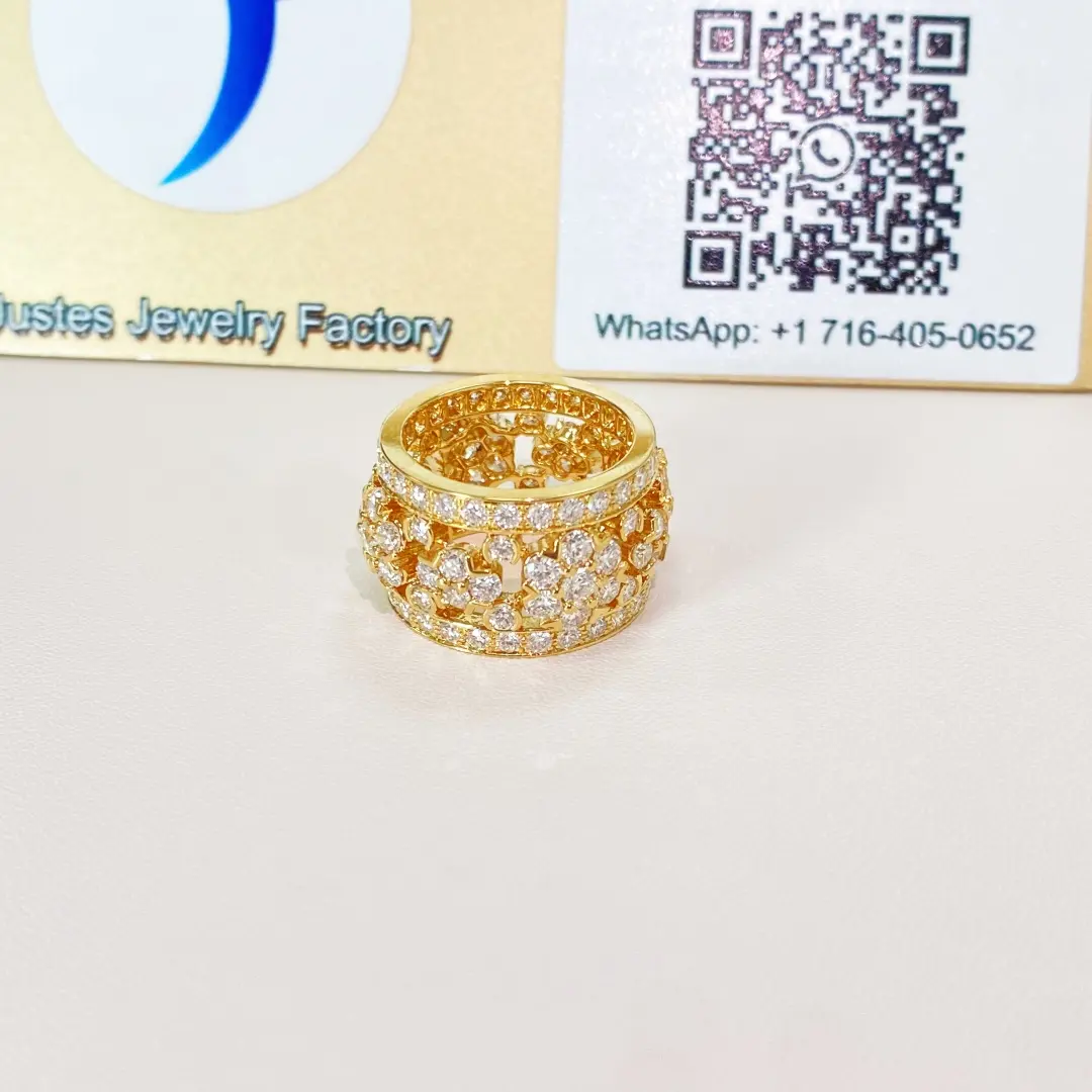 Snowflake style ring displayed in front of the Justes logo and QR display board