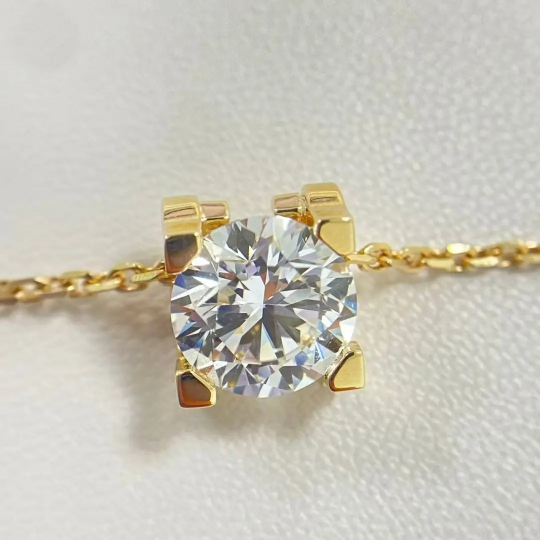 C de Cartier style round diamond pendant on a yellow gold chain