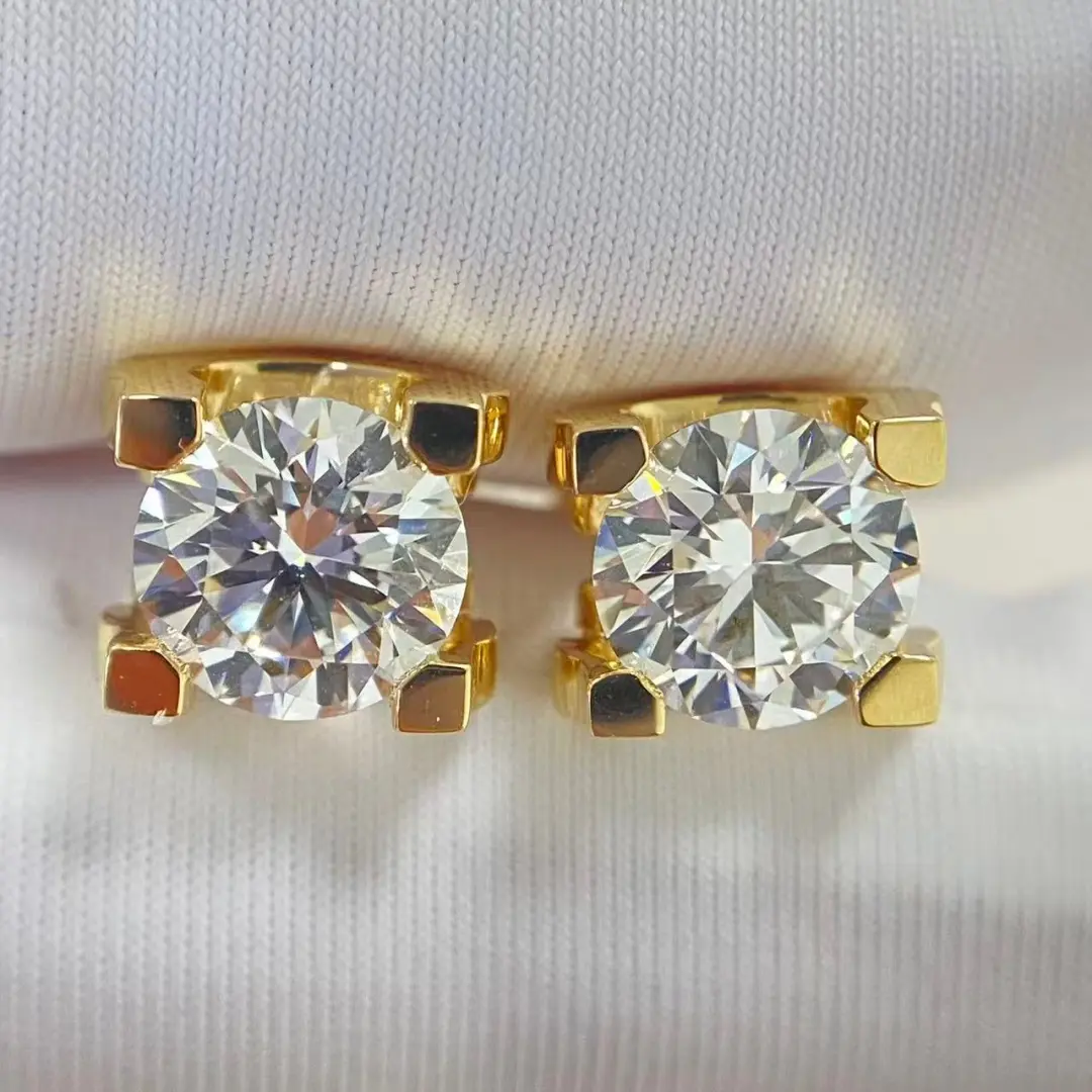 Pair of C de Cartier style yellow gold diamond studs, front view