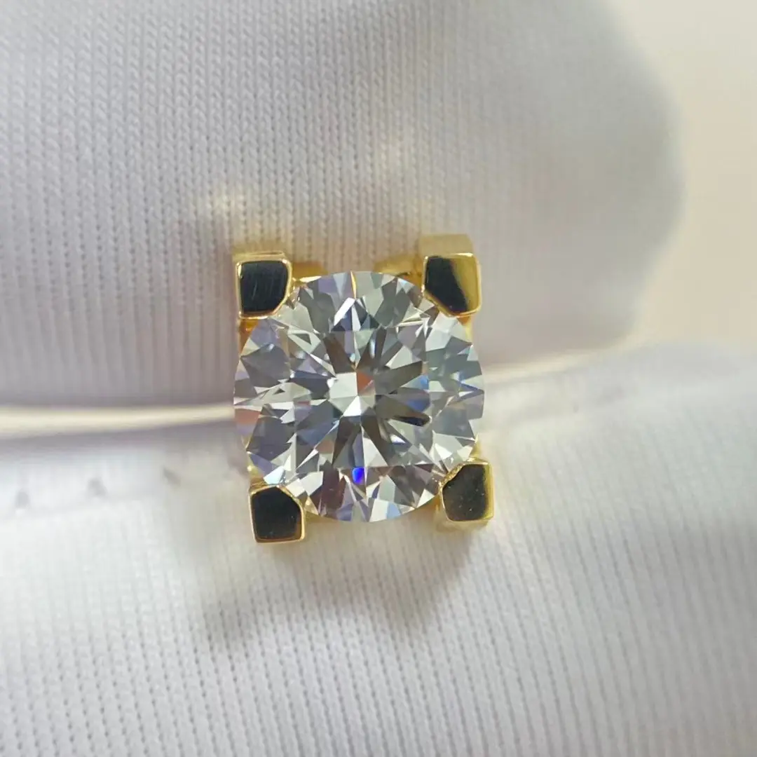 Detail view of the C de Cartier style stud earrings