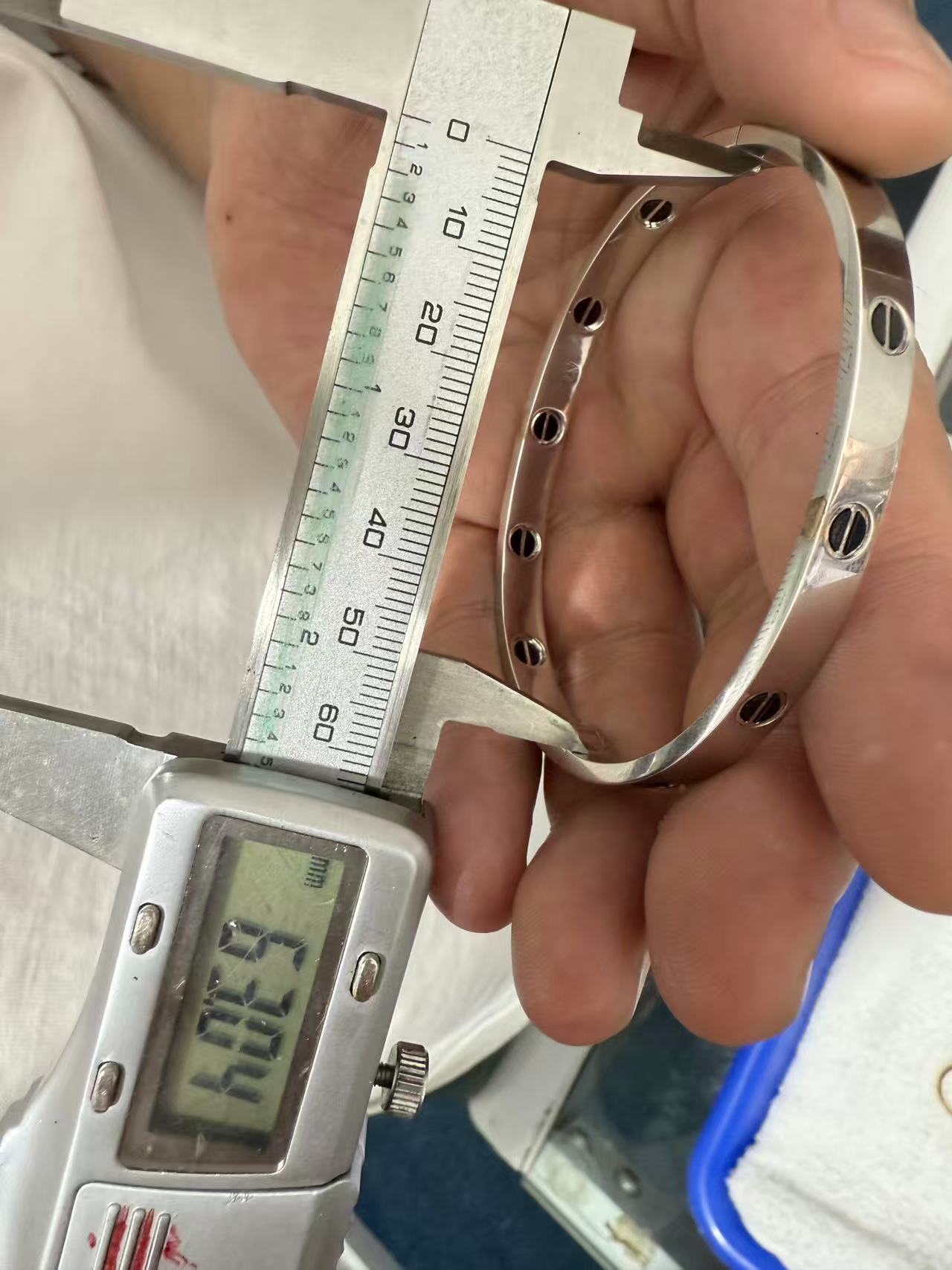 Caliper showing 63.04 mm across the longer inside span of the replica bracelet