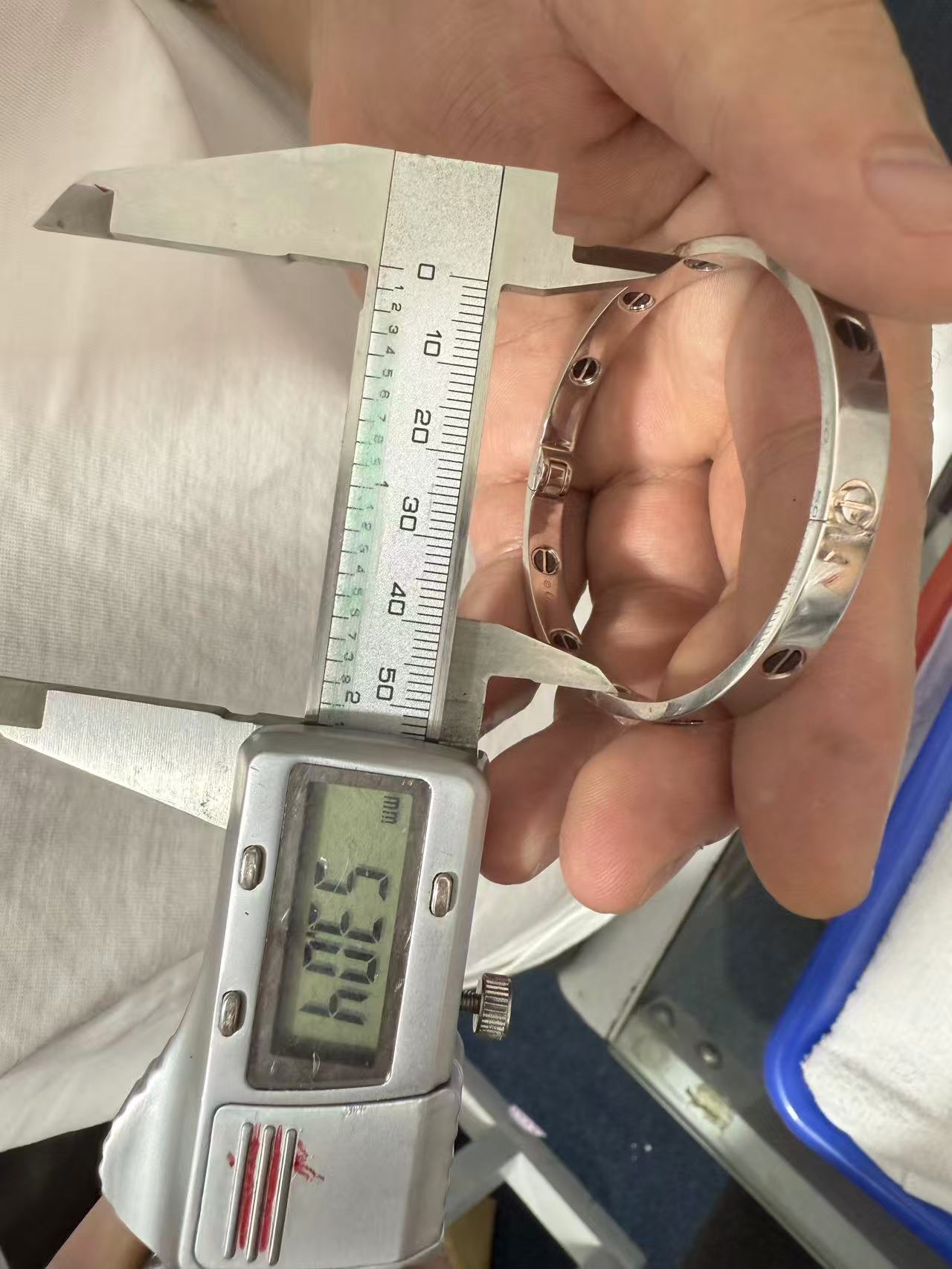 Caliper showing 53.04 mm across the shorter inside span of the replica bracelet
