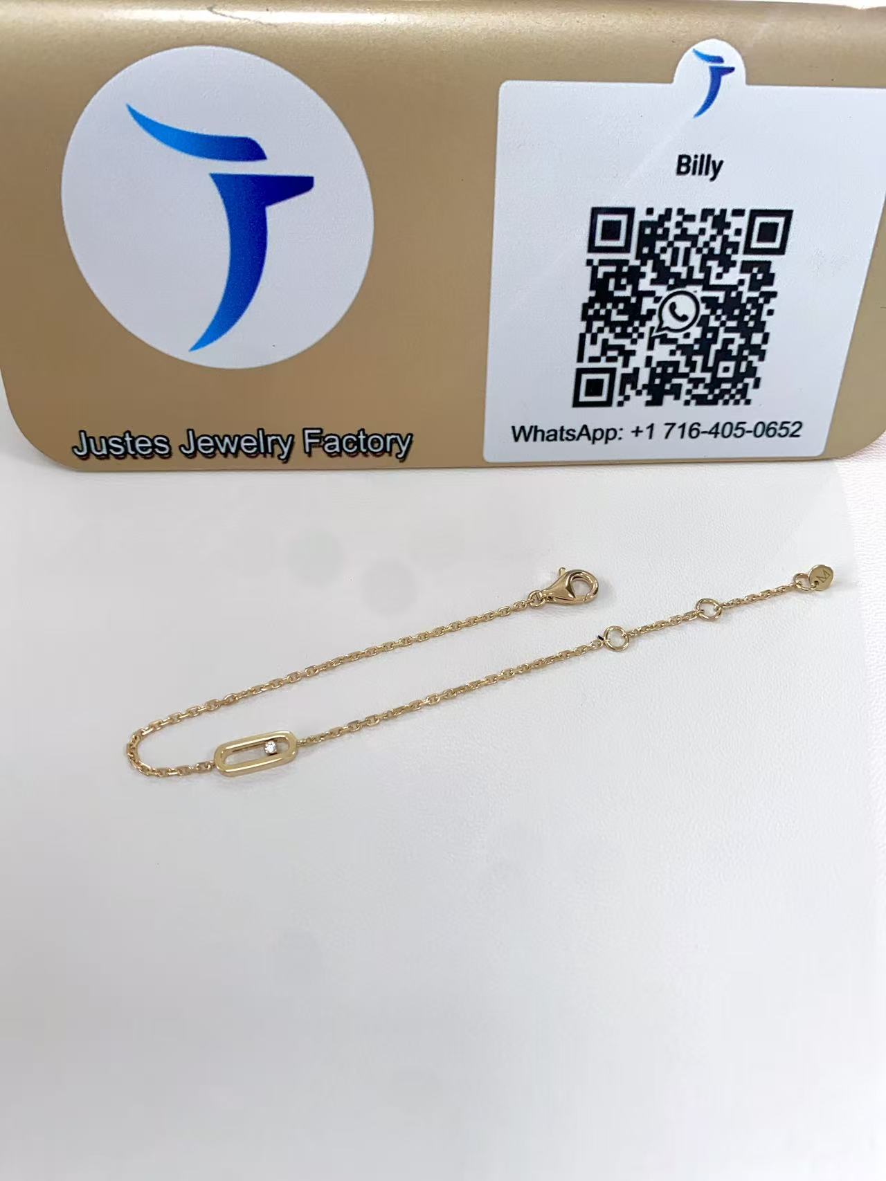 Move Uno style mini bracelet displayed in front of the Justes logo and QR code sign