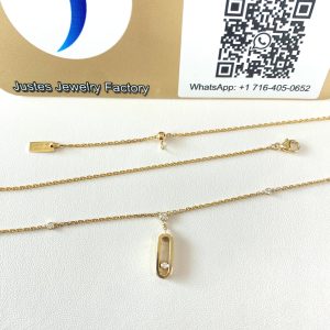 Move Uno style pendant necklace and chain displayed in front of the Justes logo and QR code sign