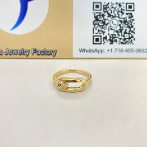 Move Uno style large ring in yellow gold displayed in front of a Justes logo and QR code sign