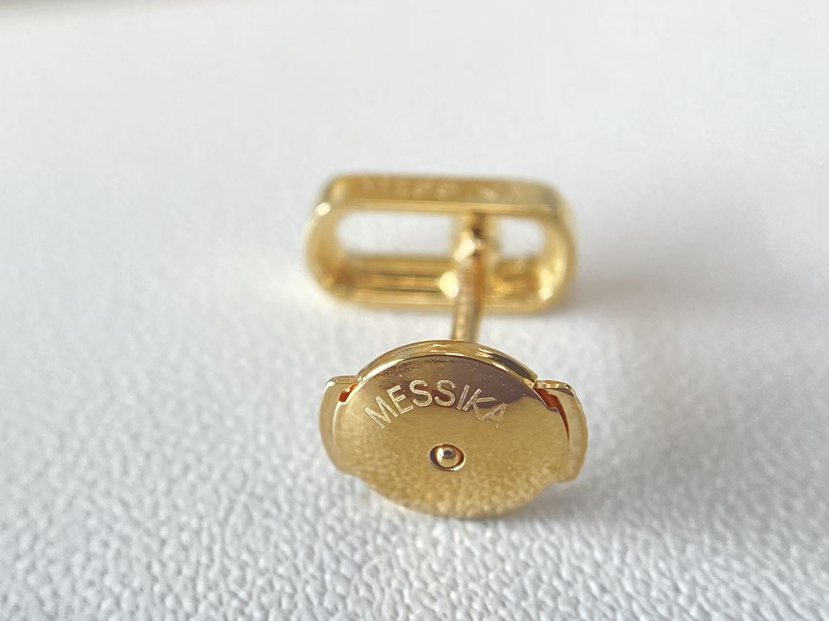 Earring backing detail for the Move Uno style yellow gold stud earrings