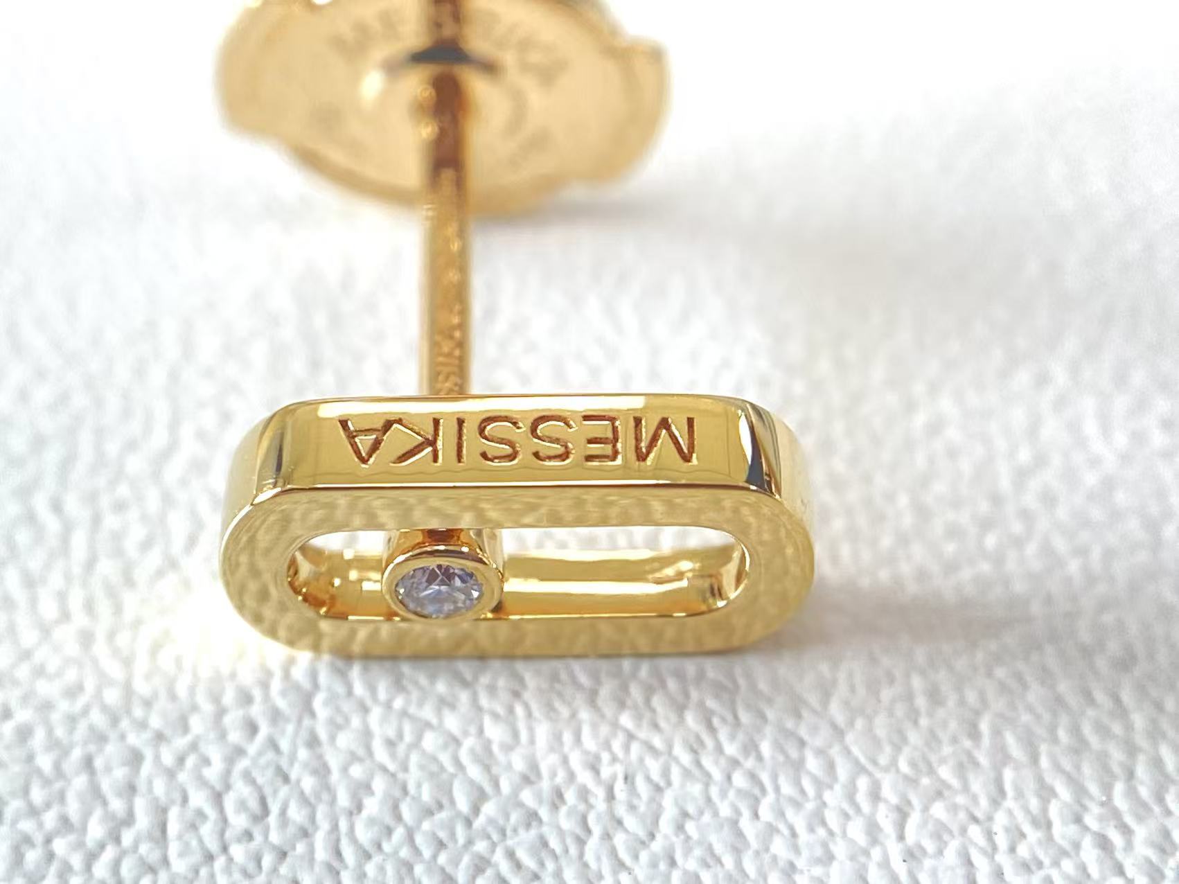 Single Move Uno style yellow gold diamond stud shown from the front with post and backing