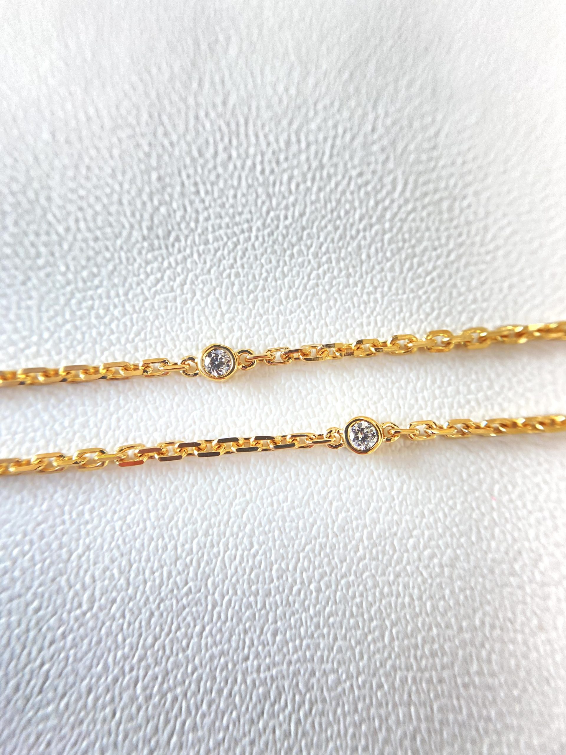 Yellow gold necklace with round bezel-set accents along the chain